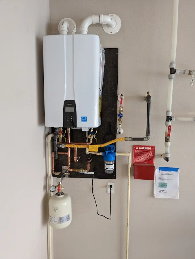 Professional plumber installing copper piping in a Warminster home